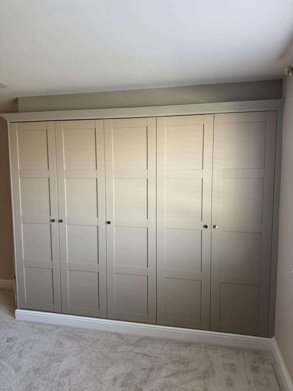 Five-door floor-to-ceiling shaker wardrobes in soft stone