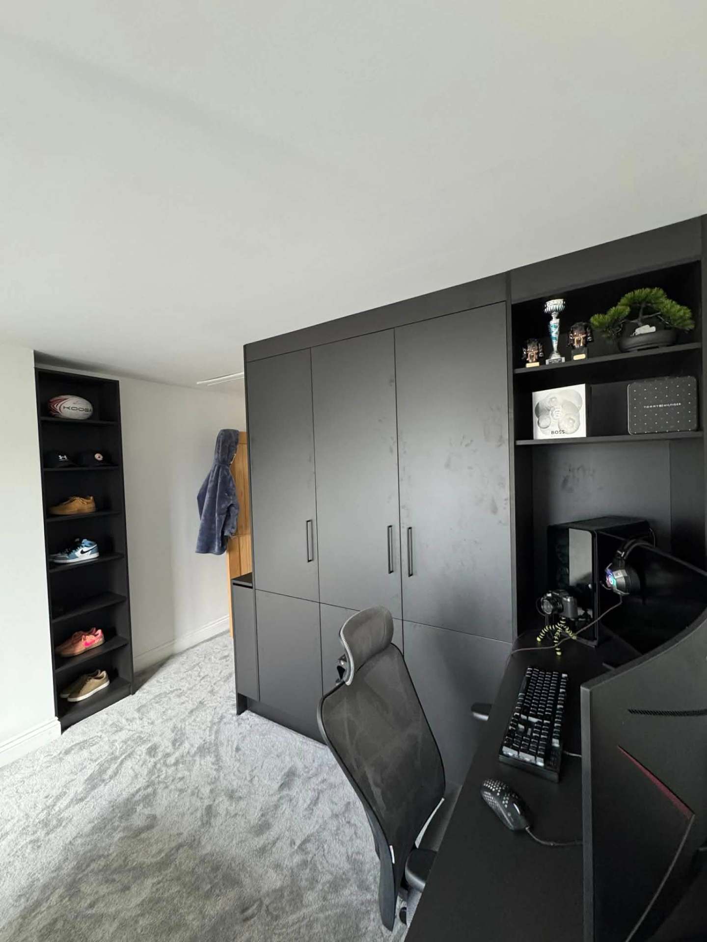 Matte black built-in wardrobes with integrated gaming desk & shelving
