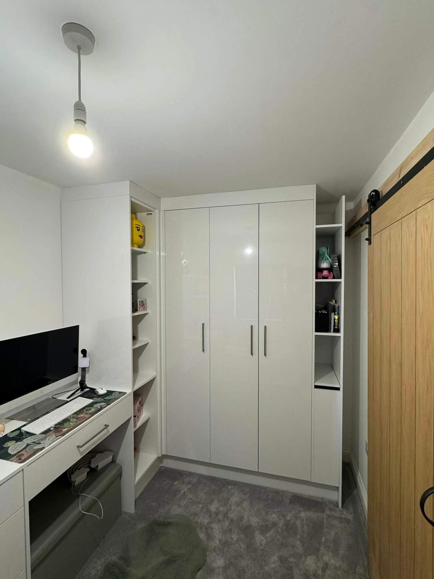 High-gloss white wardrobes with desk, sliding barn door & open shelving